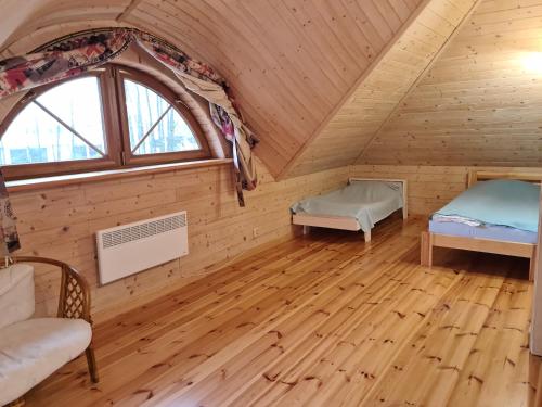 Postel nebo postele na pokoji v ubytování Willa-Ranczo Gródek