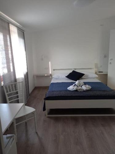 a bedroom with a bed with a blue comforter at Bouganville da Giò in Scalea