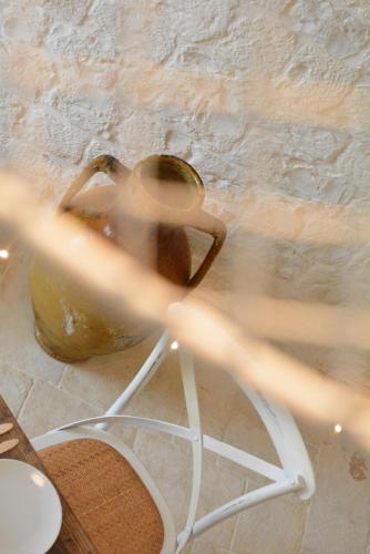 a blurry picture of a metal vase on a table at LuX - Exclusive Trulli Relax in Alberobello