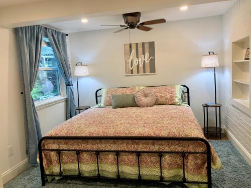 a bedroom with a bed and a ceiling fan at Lamb's Rest Inn in New Braunfels