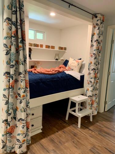 a bedroom with a bunk bed with a curtain at Lamb's Rest Inn in New Braunfels