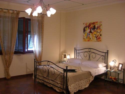 a bedroom with a bed and a painting on the wall at Pietra Preziosa Bed & Breakfast in Pietra Ligure