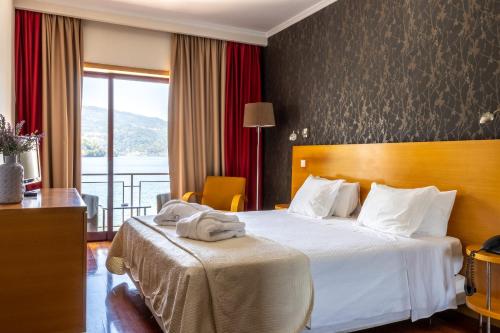 מיטה או מיטות בחדר ב-Douro Hotel Porto Antigo