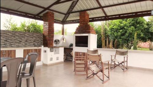 un patio con chimenea, mesa y sillas en Rancho Colorado, en Pitalito