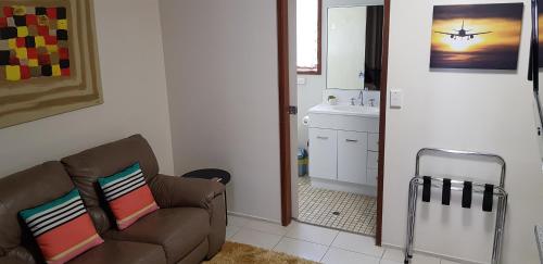 a living room with a couch and a sink at Gold Coast Airport Motel - Only 300 Meters To Airport Terminal in Gold Coast