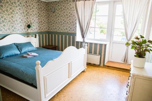 a bedroom with a white bed and a window at 4 bedroom 166m2 apartment with sauna in the city 600m from the beach in a quiet family residence in Kuressaare