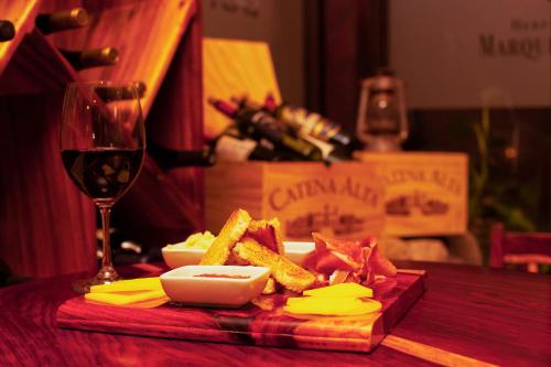 a plate of food and a glass of wine on a table at Hacienda La Pacífica Eco-Lodge in Cañas
