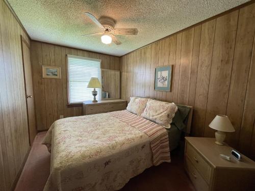 a bedroom with a bed and a ceiling fan at SOUTHERN STAR cottage in Hatteras