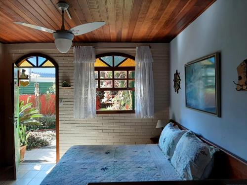 una camera con letto e ventilatore a soffitto di Pousada Estrela do Mar a Florianópolis