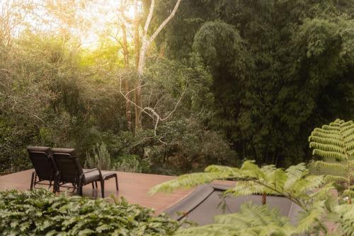 two chairs sitting on top of a wooden deck at Runawaytomaleny in Maleny