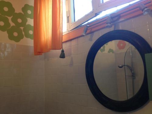 a mirror on a wall in a bathroom at Casa Olivia in Florence