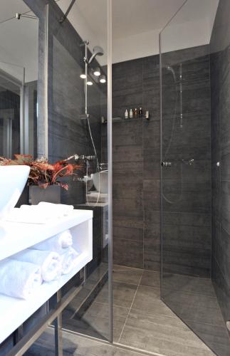 a bathroom with a glass shower and a sink at Apartments & Rooms Lavandula Exclusive in Zadar