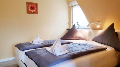 a bedroom with two beds with pillows on them at Ferienwohnung-Kirsten in Sankt Peter-Ording