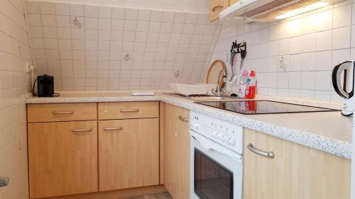 a kitchen with a sink and a dishwasher at Ferienwohnung-Kirsten in Sankt Peter-Ording