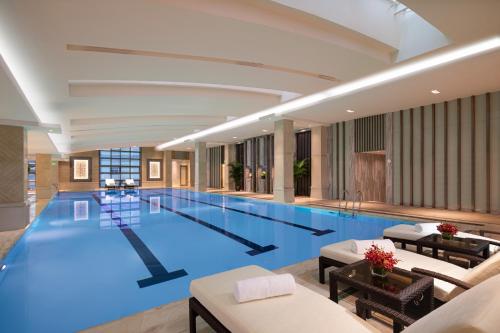 a large swimming pool in a hotel lobby at Crowne Plaza Shanghai Nanjing Road, an IHG Hotel in Shanghai