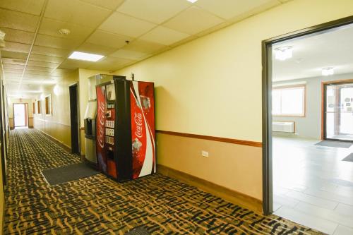 an empty hallway with a cocacola soda machine at Super 8 by Wyndham McLean/Bloomington SW in McLean