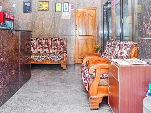 a room filled with chairs and a table at Hotel Sahasra Residency in Tirupati