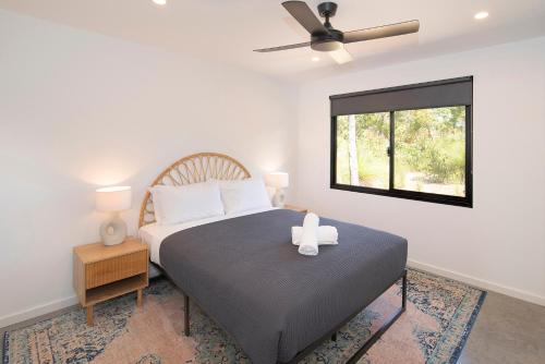 A bed or beds in a room at River Mouth Beach House