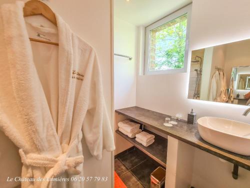 a bathroom with a shower curtain and a sink at Château des Lumières Gîte et gîte insolite in Saint-Blimont