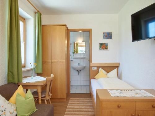 a small room with a bed and a bathroom at Beim Dobler in Höslwang