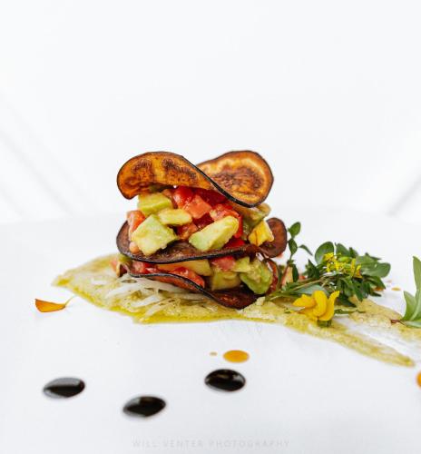 a sandwich with vegetables on a white plate at Zanziblue Boutique Villas in Matemwe