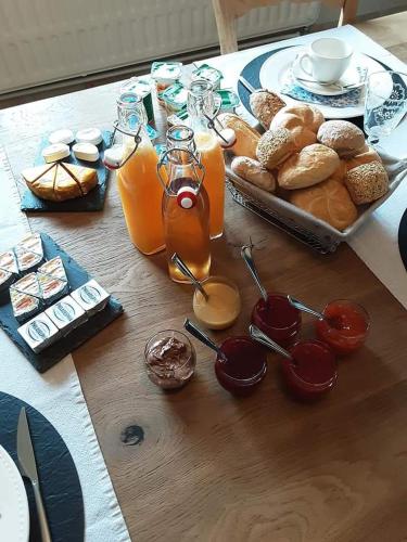a table with a bunch of breakfast foods and drinks at L' Ancienne Ferme in Marche-en-Famenne