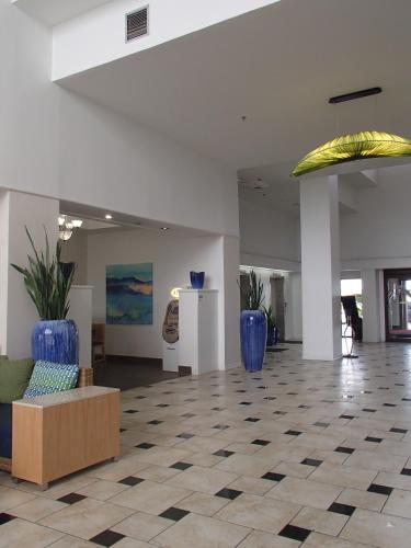 a lobby with two large blue vases on the floor at DoubleTree by Hilton Corpus Christi Beachfront in Corpus Christi