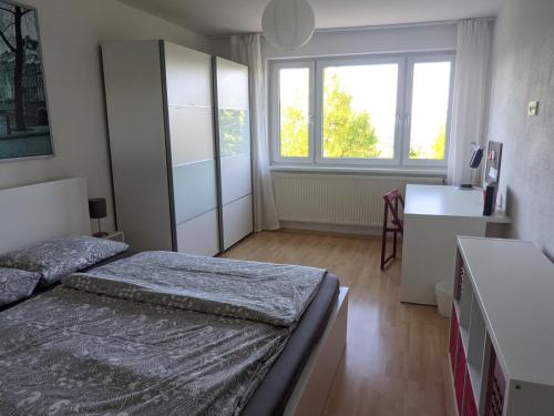 a small bedroom with two beds and a window at Ferienwohnungen Vera & Lea in Friedrichshafen