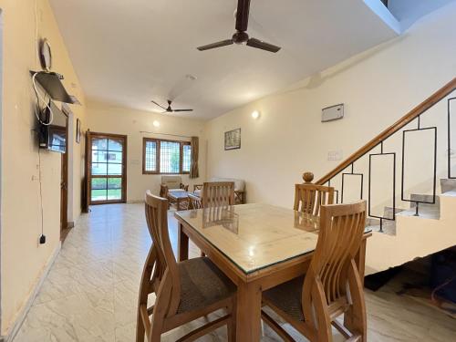 a dining room with a wooden table and chairs at EKO STAY - Cliff Haven Villa in Bhīm Tāl