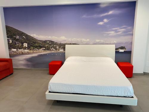 a bedroom with a bed and a view of the beach at Torre del mare Rooms in Bergeggi