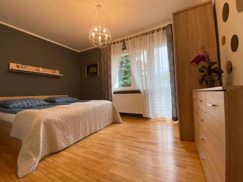 a bedroom with a bed and a window at Apartamenty Straconka ,Bielsko-Biala in Bielsko-Biala