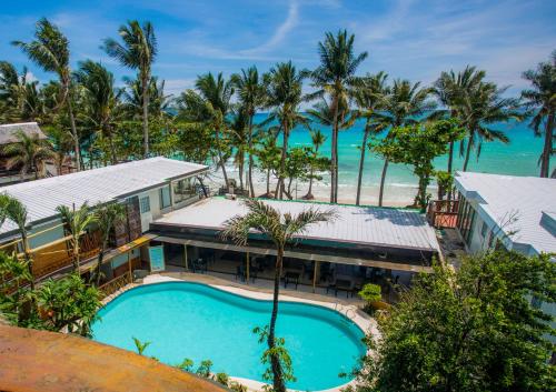an aerial view of a resort with a swimming pool and the ocean at Red Coconut Beach Hotel Boracay in Boracay