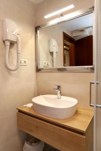a bathroom with a sink and a mirror at Villa Carrara in Trogir