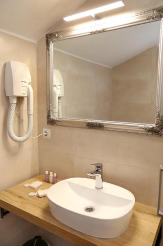 a bathroom with a sink and a mirror at Villa Carrara in Trogir