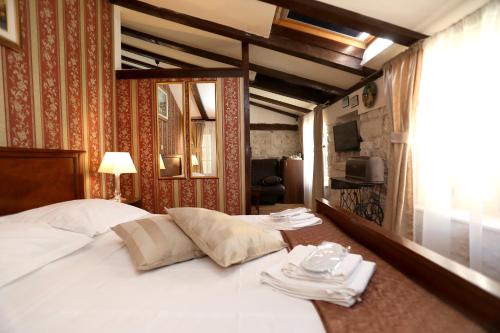 a hotel room with a bed with white towels on it at Villa Carrara in Trogir