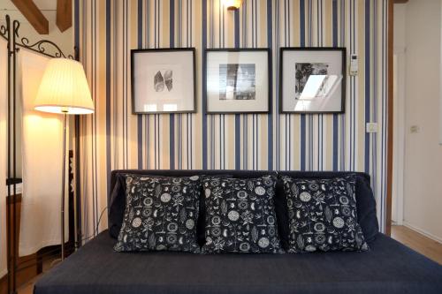 a bedroom with a bed with four pictures on the wall at Villa Carrara in Trogir