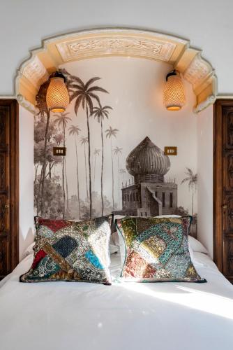 a bedroom with a large white bed with two pillows at Pájaro Rebelde in Seville