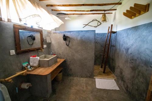 a bathroom with a sink and a mirror at Nest Style Beach Hotel Zanzibar in Makunduchi