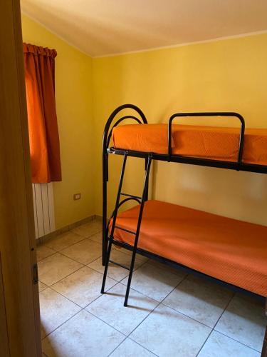a bedroom with two bunk beds in a room at Appartamento l’Akorea in Convento
