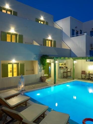 a large swimming pool in front of a house at Studios Marios in Kamari
