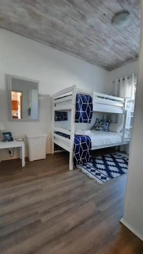 a room with two bunk beds and a mirror at Ons Fontein in Langebaan