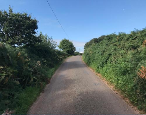 a dirt road between two grassy hills at The Cheese Room, self-contained cosy retreat in the Quantock Hills in Bridgwater