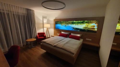 a hotel room with a bed and a large painting on the wall at Der Adler in Lauchringen