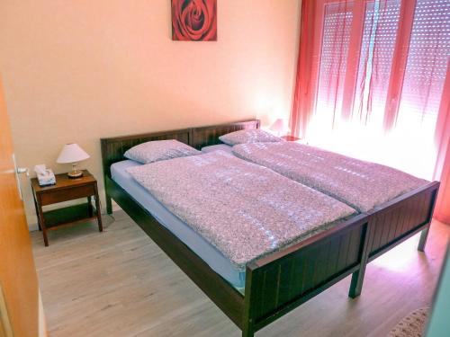 a bedroom with a wooden bed with a window at Apartment Impéria 10 by Interhome in Crans-Montana