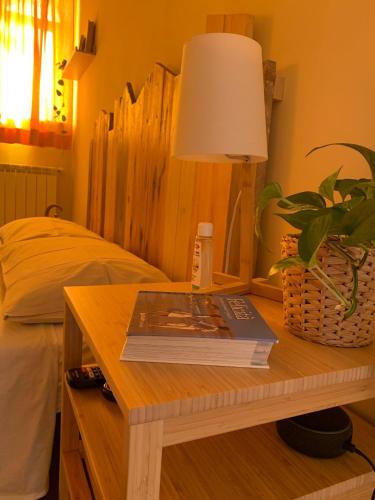 a table with a book and a lamp on top of it at Agriostello Riparo in Anzio