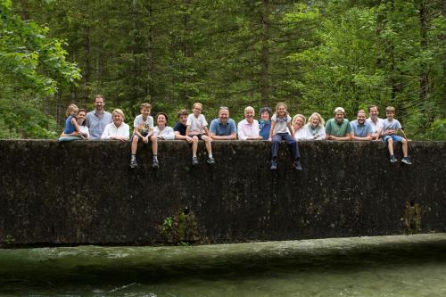 a group of people sitting on top of a wall at Genießerhotel Döllerer in Golling an der Salzach