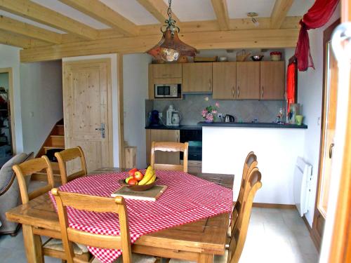 a kitchen and dining room with a table with fruit on it at Chalet L'Escapade by Interhome in Ovronnaz