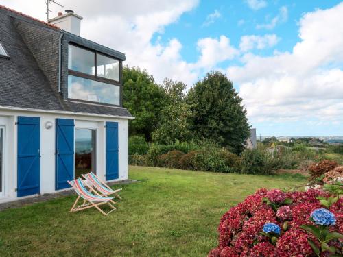 a house with two lawn chairs in the yard at Holiday Home Ti Loïk by Interhome in Plouézec