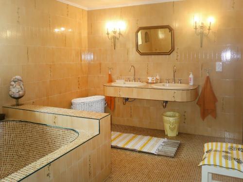 a bathroom with a sink and a mirror at Holiday Home Le Manoir by Interhome in Pont-lʼAbbé