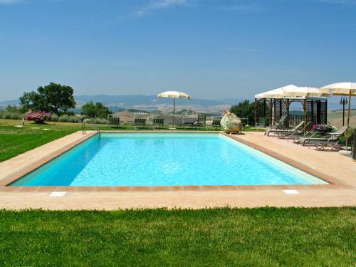 a swimming pool in the middle of a grass field at Holiday Home San Lorenzo-1 by Interhome in La Cava
